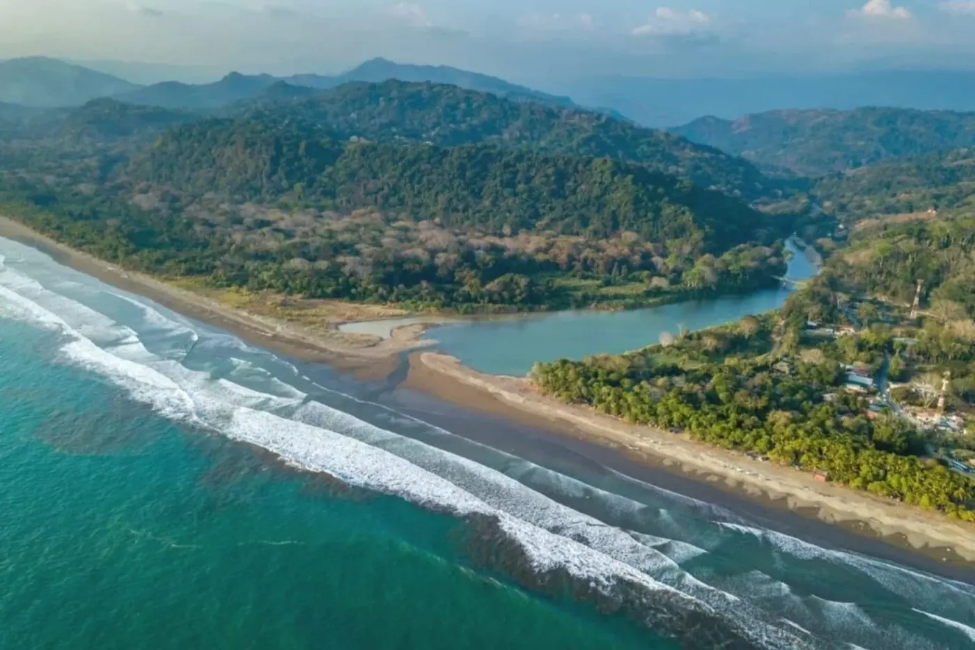 The long surf beach and river mouth at Playa Dominical