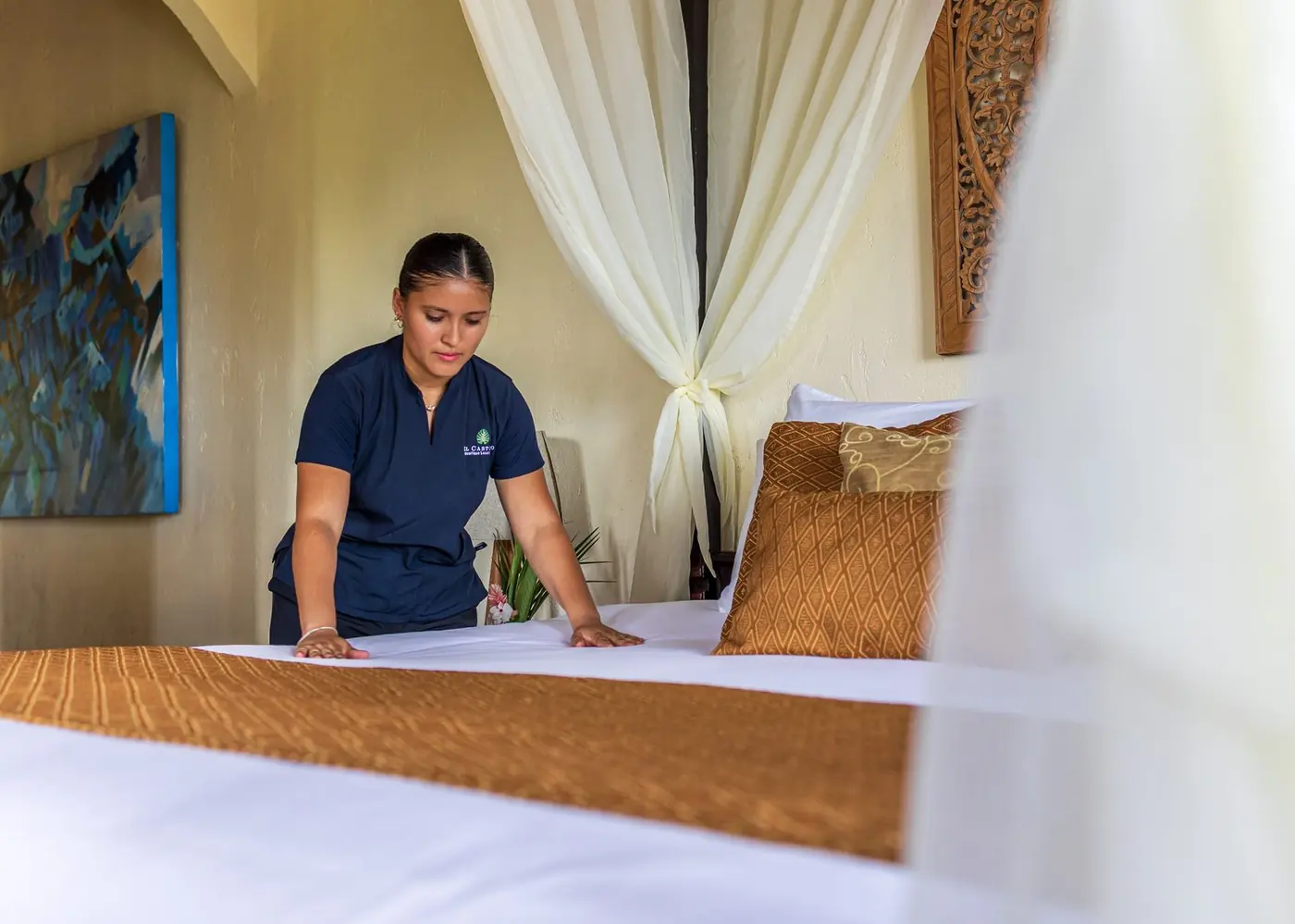 Housekeeper smoothing crisp white linens